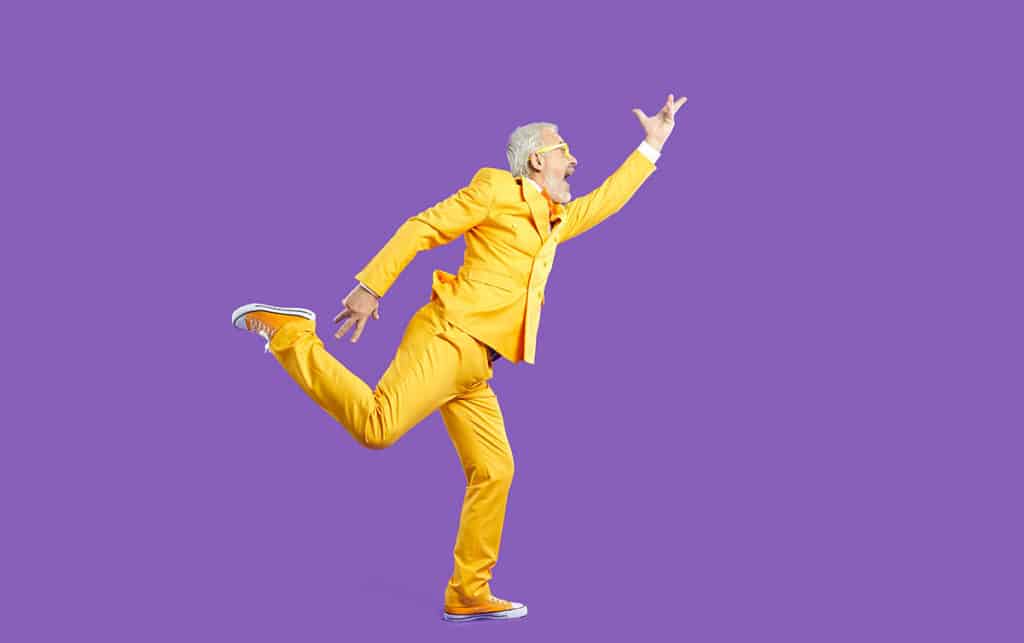 Man in yellow suit gesticulating wildly